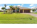 Beautiful house with a three-car garage and manicured lawn at 912 Boundary Blvd, Rotonda West, FL 33947
