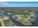 Waterfront property showcasing a canal-front home with a backyard at 9222 Melody Cir, Port Charlotte, FL 33981
