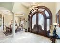 Grand entryway with a stunning arched doorway and tile flooring at 150 Mandalay Rd, Punta Gorda, FL 33950