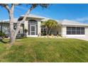 House exterior features landscaping and screened porch at 15546 Viscount Cir, Port Charlotte, FL 33981