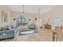 Living room with tiled floors and large window at 15546 Viscount Cir, Port Charlotte, FL 33981