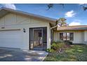 Front entrance with screened porch and attached garage at 1951 Greenlawn Dr, Englewood, FL 34223