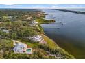 An aerial view of a home on the waterfront with a large lot at 1990-B Bayshore Dr, Englewood, FL 34223