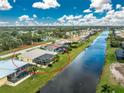 Bird's-eye view of a home showcasing backyard oasis, pool, and canal view at 233 Marker Rd, Rotonda West, FL 33947