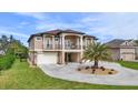 Two-story home with three-car garage and circular driveway at 710 Albee W Rd, Nokomis, FL 34275