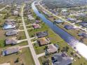 Aerial view of a canal front property showing the lot and surrounding houses at 738 Boundary Blvd, Rotonda West, FL 33947