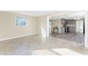 Bright living room with tile flooring and open view to kitchen at 850 E 2Nd St, Englewood, FL 34223