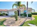 Landscaped front yard with a single-story house and palm trees at 11479 Blackfin St, Venice, FL 34292