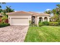 House exterior featuring a two-car garage and well-maintained lawn at 13376 Creekside Ln, Port Charlotte, FL 33953