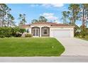 Single-story house with a two-car garage and a well-maintained lawn at 13478 Carrie Ave, Port Charlotte, FL 33953