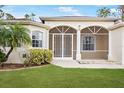 Enclosed porch with white framed windows and a white door at 13478 Carrie Ave, Port Charlotte, FL 33953