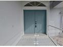 Front entrance with double doors and a walkway at 142 Broadmoor Ln, Rotonda West, FL 33947