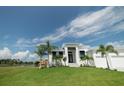 White house with two-car garage, overlooking a canal at 159 Colony Point Dr, Punta Gorda, FL 33950