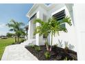 Landscaped walkway leading to the front entrance of a house at 159 Colony Point Dr, Punta Gorda, FL 33950