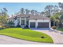 Stunning exterior of a two-story home with a three-car garage and manicured lawn at 17 Par View Pl, Rotonda West, FL 33947