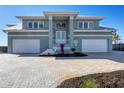 Two-story waterfront home with three-car garage and paver driveway at 1900 Illinois Ave, Englewood, FL 34224