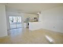 Open concept kitchen with white cabinets and a breakfast bar at 22326 Midway Blvd, Port Charlotte, FL 33952