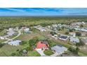 Wide aerial view showcasing the community and a home with red tile roof at 26266 Barcelos Ct, Punta Gorda, FL 33983