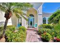 Welcoming front entry with light-colored walls, arched entryway, and teal chairs at 2864 Mill Creek Rd, Port Charlotte, FL 33953