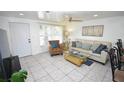 Cozy living room featuring tile flooring, a comfortable sofa, and a ceiling fan at 4064 Harbor Blvd, Port Charlotte, FL 33952