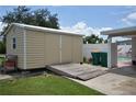 Exterior view of the property's storage shed with a ramp and adjacent garbage receptacles at 4064 Harbor Blvd, Port Charlotte, FL 33952