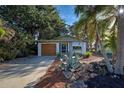 Front view of a renovated mid-century home with a spacious driveway at 421 Riviera St, Venice, FL 34285