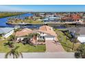 Bird's-eye view of waterfront property with boat and canal at 4557 Colleen St, Port Charlotte, FL 33952