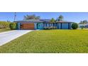 Cute bungalow with modern garage door and landscaping at 7510 Kenway St, Englewood, FL 34224