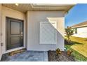 Front entrance with a welcoming doormat and landscaping at 8746 Saint Kitts Cir, Englewood, FL 34224