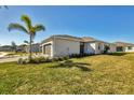 House exterior showcasing a landscaped yard and garage at 8746 Saint Kitts Cir, Englewood, FL 34224