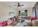 Spacious living room with sectional sofa and large TV at 9000 Griggs Rd # G, Englewood, FL 34224