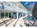 Luxury pool and spa with screened enclosure and expansive patio at 9240 Pine Cove Dr, Englewood, FL 34224