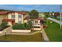 Attractive exterior of a two-story home with a red tile roof and landscaping at 93 Boundary Blvd # 301, Rotonda West, FL 33947