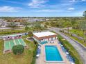 Community pool and shuffleboard courts are shown in this aerial view at 1 Quails Run Blvd # 5, Englewood, FL 34223