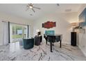 Spacious living room with marble floors, a grand piano, and comfy seating at 11247 Euler Ave, Englewood, FL 34224