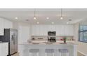 Modern kitchen with white cabinets, granite countertops, and island at 12580 Ghiberti Cir # 101, Venice, FL 34293