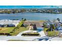 Aerial view of waterfront home with circular driveway and private dock at 1467 Deer Creek Dr, Englewood, FL 34223