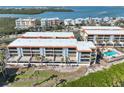 Condo building with pool and balconies overlooking the water at 1551 Beach Rd # 205, Englewood, FL 34223