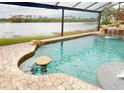 Relaxing pool area with lake view and swim-up bar at 170 Antilla Dr, Rotonda West, FL 33947