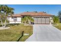 Single-story home with brown roof, attached garage, and palm trees at 197 Bunker Rd, Rotonda West, FL 33947