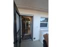 Open door revealing condo interior with tiled floors at 244 Saint Augustine Ave # 102, Venice, FL 34285