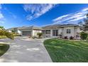 Home's exterior, featuring a two-car garage and landscaped yard at 249 Sportsman Rd, Rotonda West, FL 33947