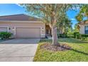 Tan house with three-car garage and mature landscaping at 2888 Myakka Creek Ct., Port Charlotte, FL 33953