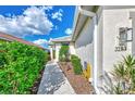 Sidewalk leads to the entrance of the house, with manicured landscaping at 3283 Osprey Ln, Port Charlotte, FL 33953