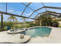 Screened pool and spa with tropical landscaping at 3310 Bay Ridge Way, Port Charlotte, FL 33953