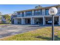 Condo building with parking under the building and additional parking in front at 4260 Placida Rd # 24B, Englewood, FL 34224