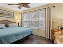 King-size bed, light teal bedding, and large window with blinds at 4410 Warren Ave # 107, Port Charlotte, FL 33953