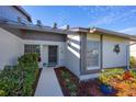 Home entrance with walkway, landscaping, and exterior lighting at 609 Deerwood Ave, Englewood, FL 34223