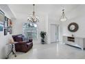 Bright and airy entryway with tile flooring and a seating area at 6256 Pennell St, Englewood, FL 34224