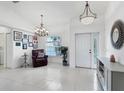 Bright and airy entryway with tile flooring and a seating area at 6256 Pennell St, Englewood, FL 34224